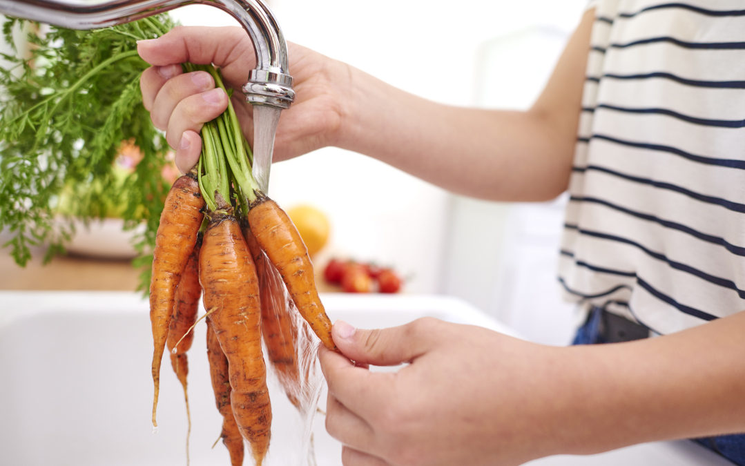 Chesterfield woman washing carrots over sink