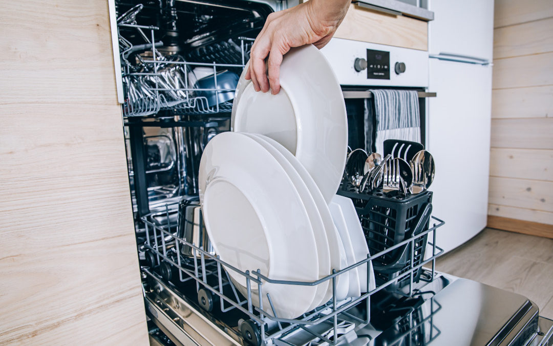 man loading up a dishwasher